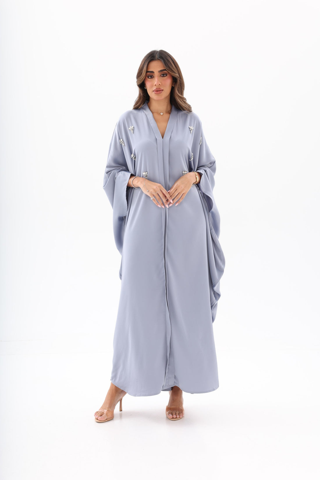 Black and light blue crystal V-neck abayas with draped sleeves and flowy maxi length.